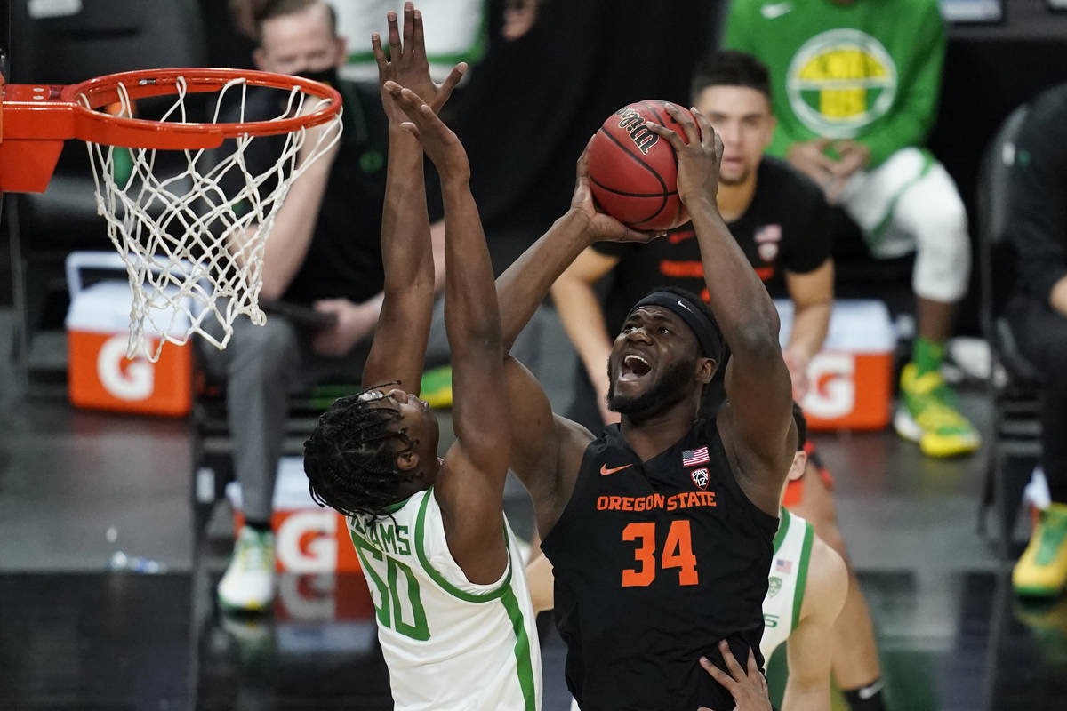 Oregon State's Rodrigue Andela (34) shoots over Oregon's Eric Williams Jr. (50) during the firs ...