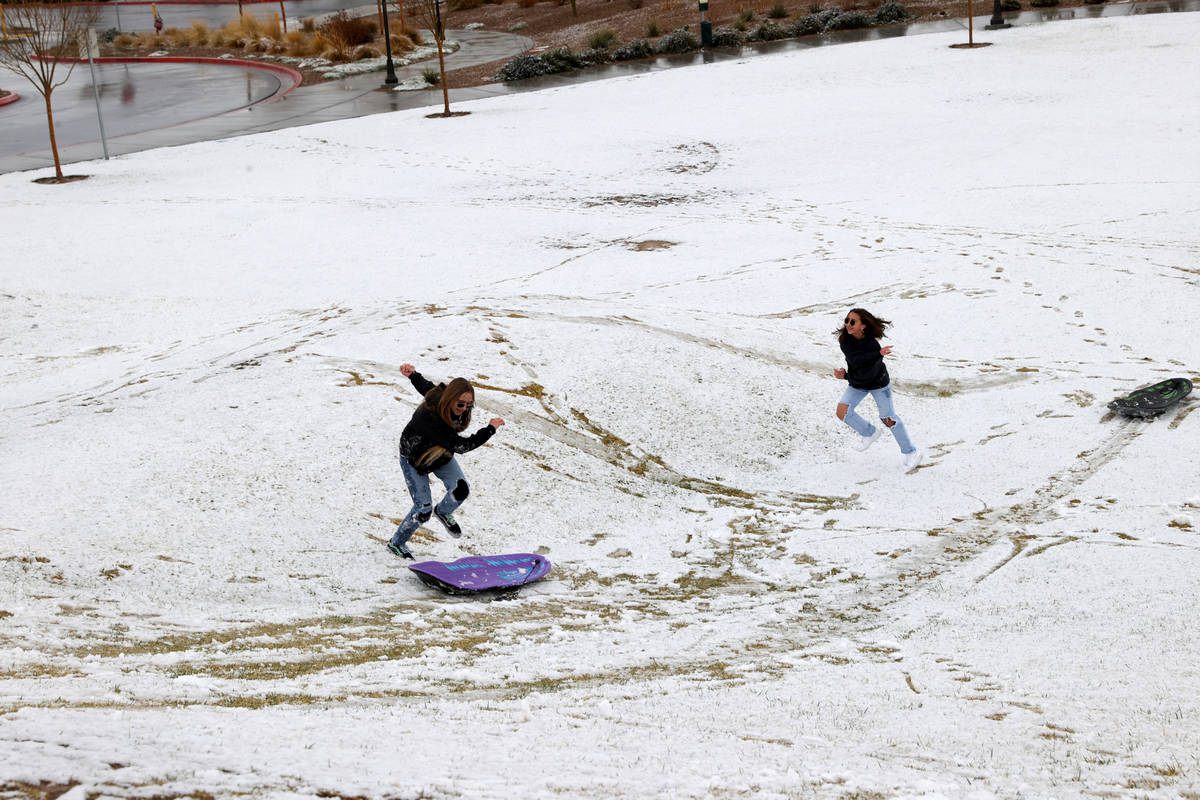 Phoebe Lee, 14, left, and Giselle Ornelas-Emerick, 13, both of Las Vegas, play in the snow at F ...