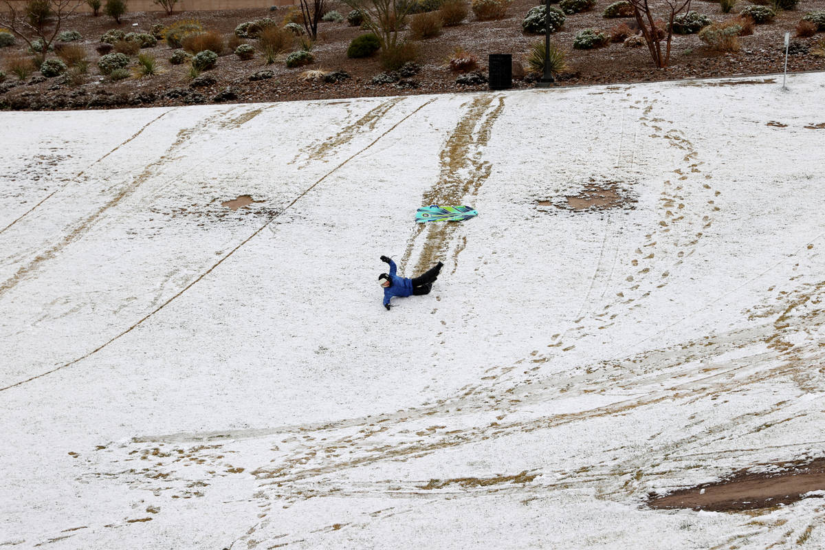Landon Morris, 9, of Las Vegas, plays in the snow at Fox Hill Park in Summerlin in Las Vegas Fr ...