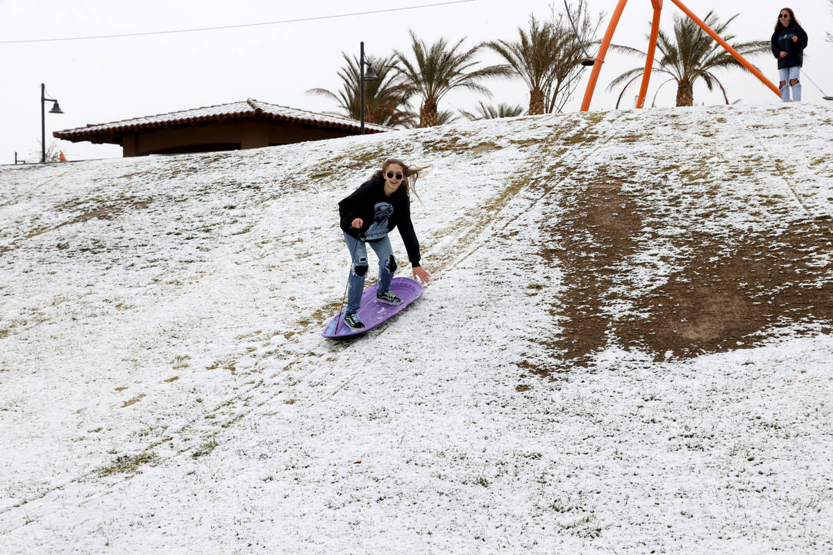 Phoebe Lee, 14, left, and Giselle Ornelas-Emerick, 13, both of Las Vegas, play in the snow at F ...
