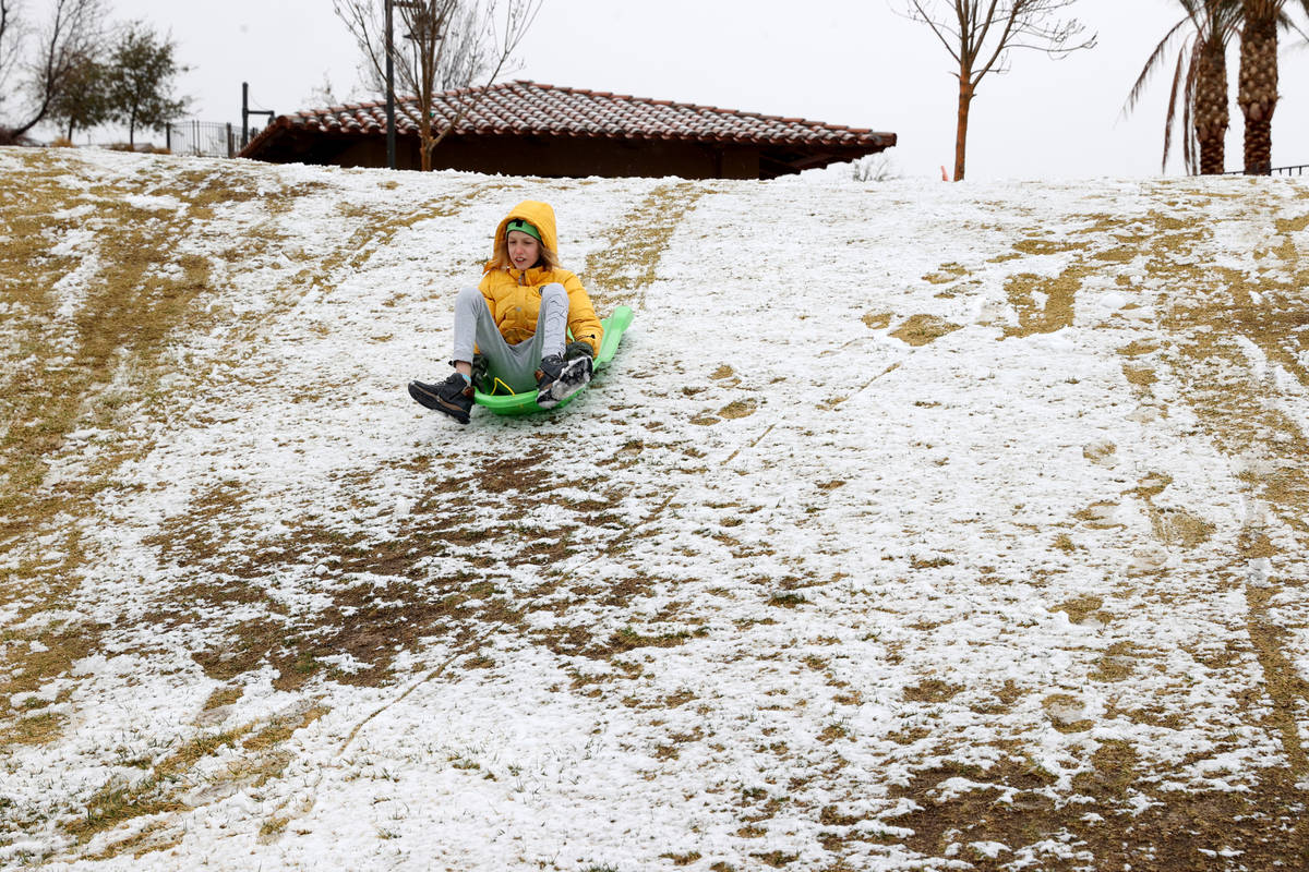 Richard Vergasov, 11, of Las Vegas, takes a sled ride in the snow at Fox Hill Park in Summerli ...