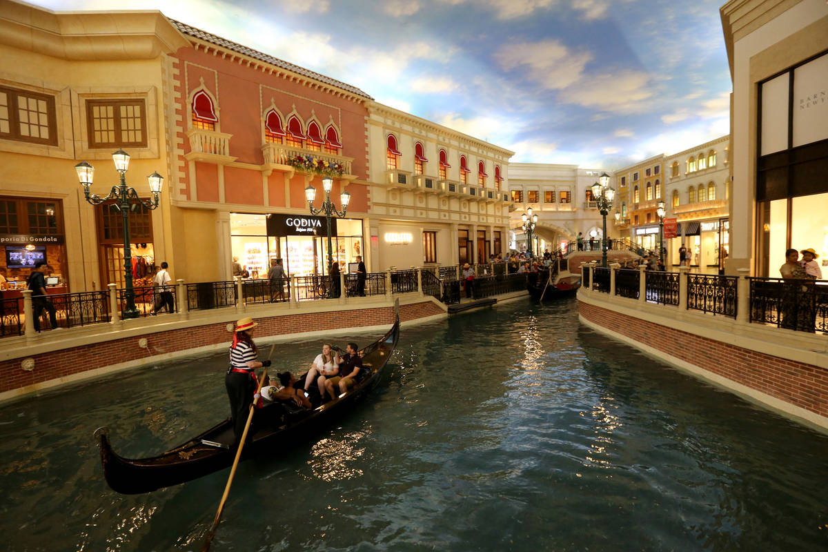 Guests take a gondola ride in the Grand Canal at The Venetian on the Strip in Las Vegas Tuesday ...