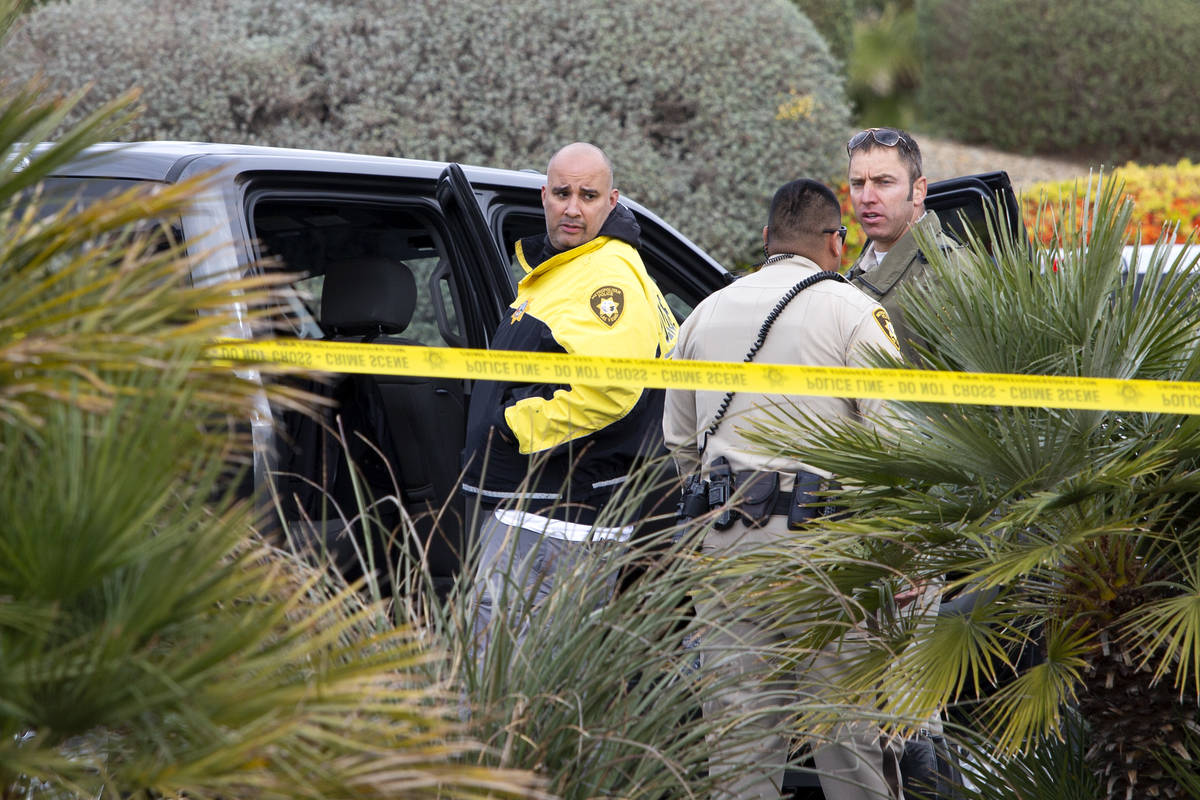 Metropolitan police investigate a crash involving two vehicles and a pedestrian at the intersec ...