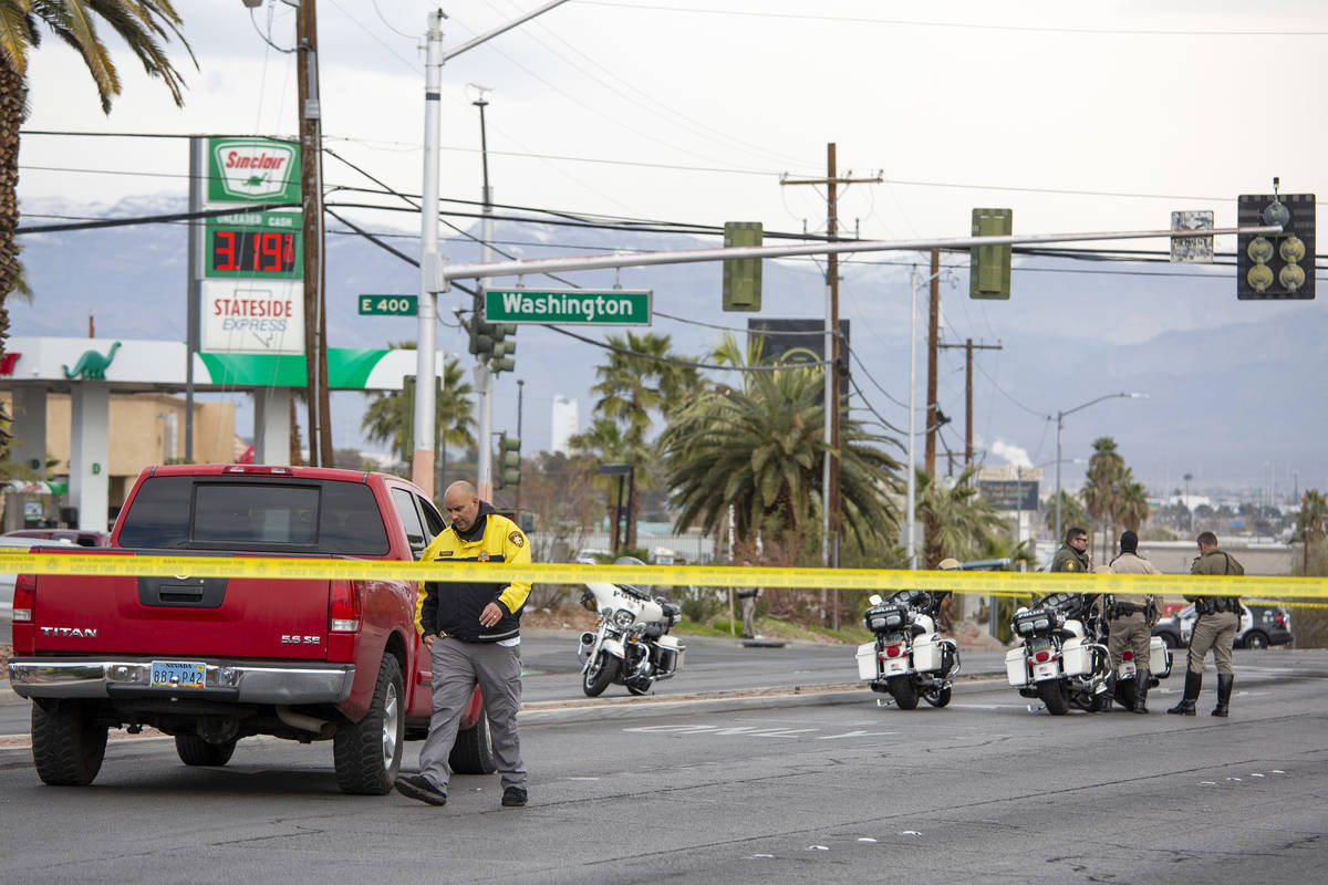 Metropolitan police investigate a crash involving two vehicles and a pedestrian at the intersec ...