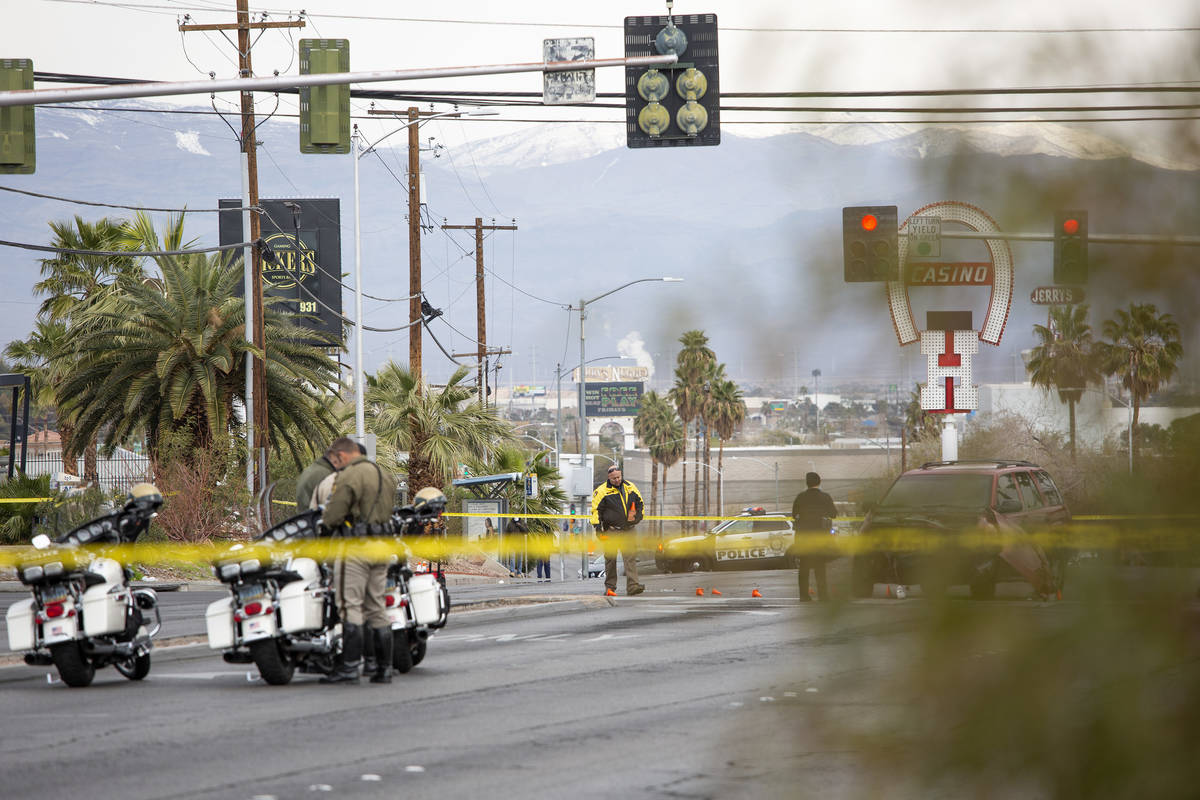 Metropolitan police investigate a crash involving two vehicles and a pedestrian at the intersec ...