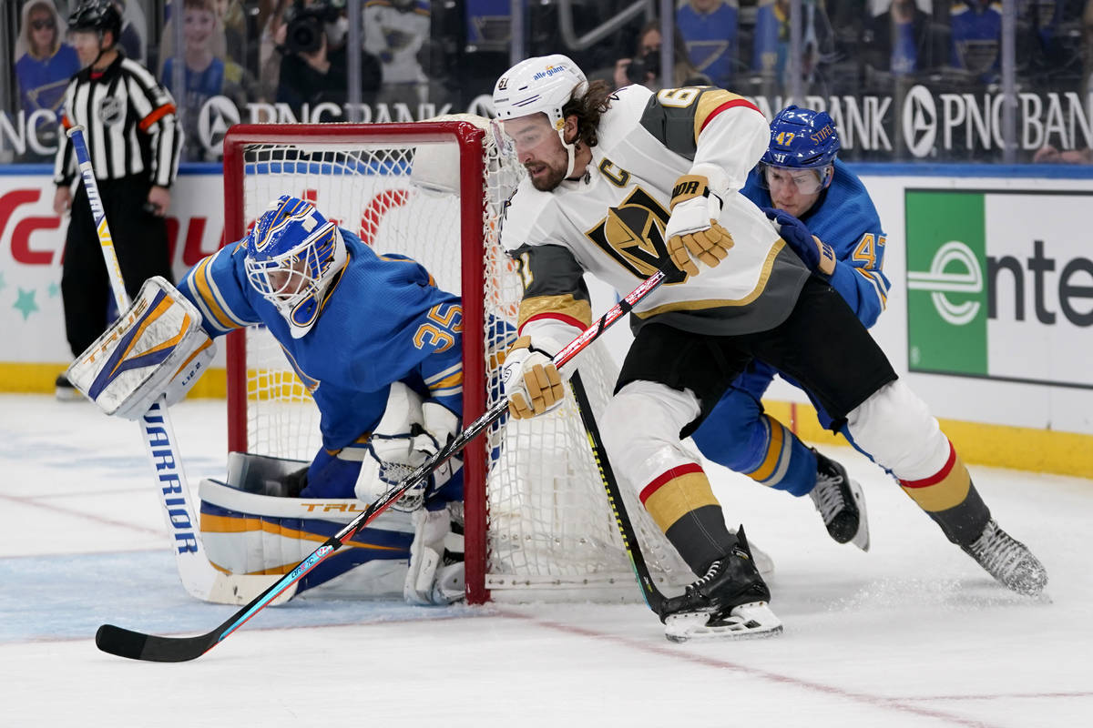 Vegas Golden Knights' Mark Stone, center, scores past St. Louis Blues goaltender Ville Husso, l ...