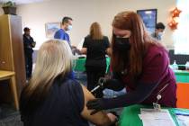 Touro University Nevada physician assistant student Brianne Gustafson, right administers the CO ...