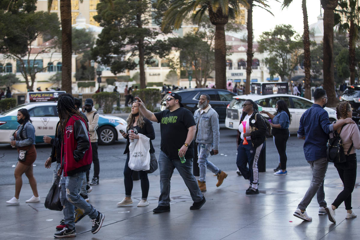 People visit the Strip near the Paris Las Vegas in Las Vegas, on Saturday, March 13, 2021. (Eri ...