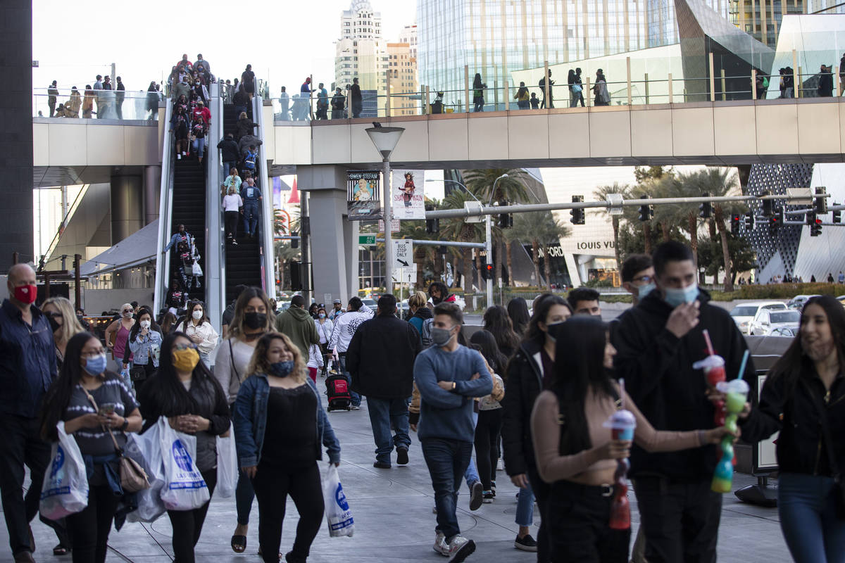 People visit the Strip near the Planet Hollywood hotel-casino in Las Vegas, on Saturday, March ...
