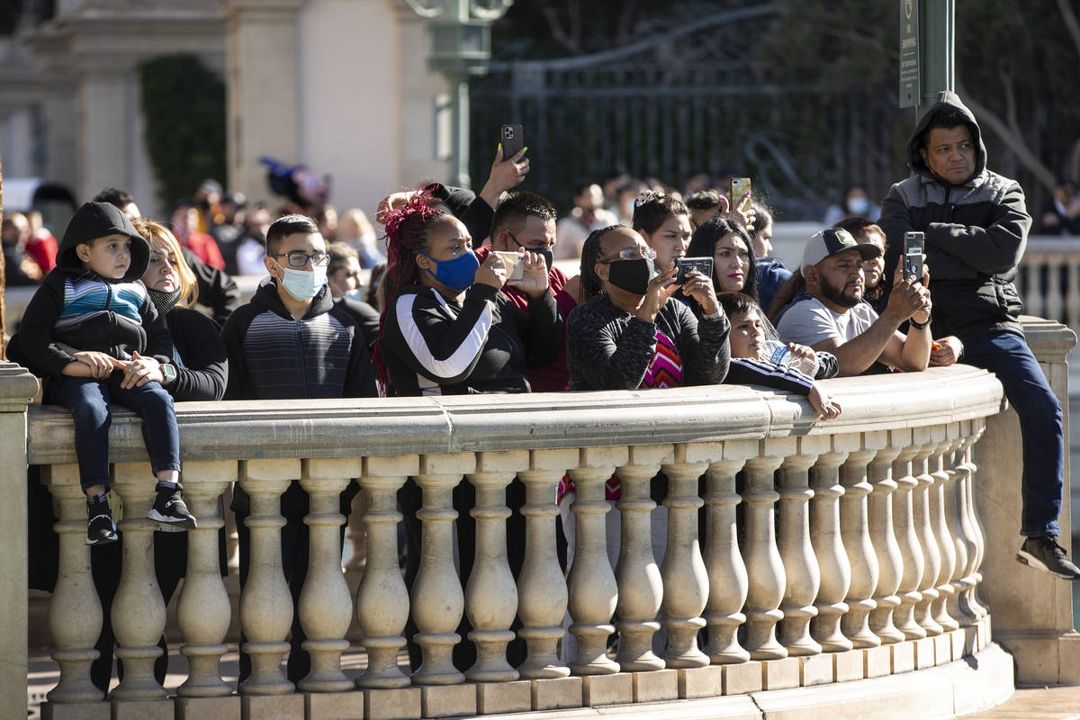 People watch the Fountains of Bellagio show at the Strip in Las Vegas, on Saturday, March 13, 2 ...