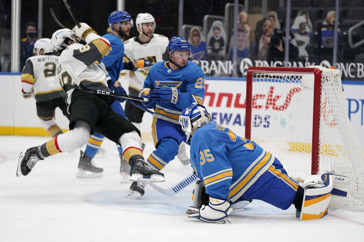 St. Louis Blues goaltender Ville Husso (35) watches as Vegas Golden Knights' Alex Tuch, left, s ...