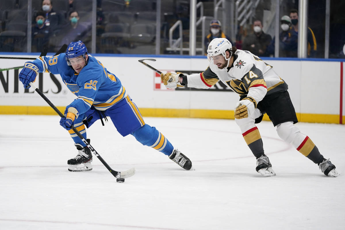 St. Louis Blues' Vince Dunn (29) passes as Vegas Golden Knights' Nicolas Hague (14) defends dur ...