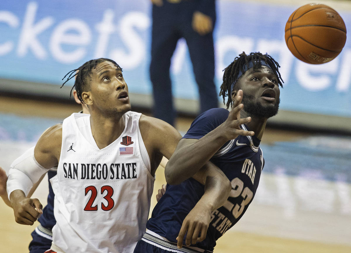 San Diego State Aztecs forward Joshua Tomaic (23) fights for a loose ball with Utah State Aggie ...