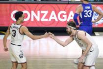 Gonzaga guard Andrew Nembhard (3) and forward Drew Timme (2) celebrate after they defeated BYU ...