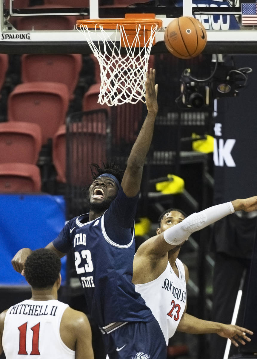 Utah State Aggies center Neemias Queta (23) fights for a loose ball with San Diego State Aztecs ...