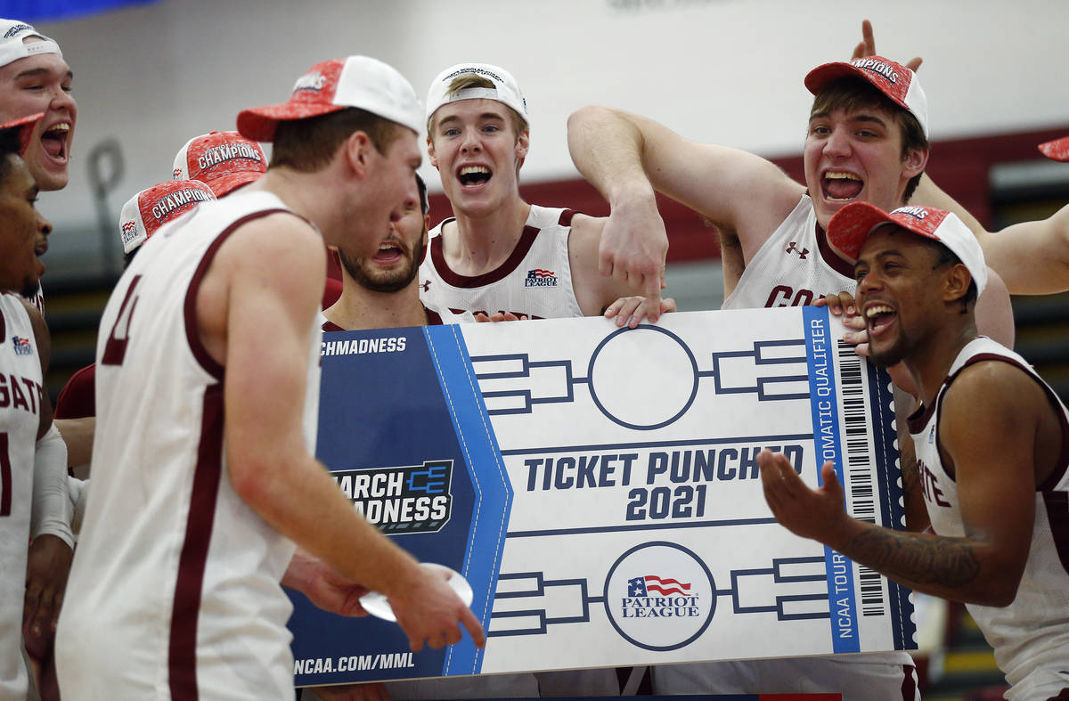 Colgate players celebrate beating Loyola (Md.), in an NCAA college basketball game in the final ...