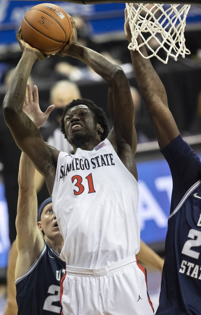 San Diego State Aztecs forward Nathan Mensah (31) drives to the rim past Utah State Aggies guar ...