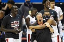 San Diego State Aztec players celebrate with head coach Brian Dutcher, right/front, after winni ...