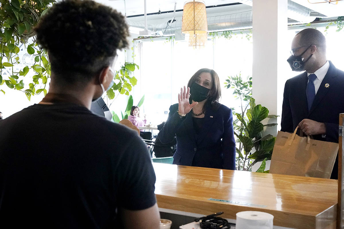 Vice President Kamala Harris, right, talks to employees while stopping for lunch at Tacotarian, ...