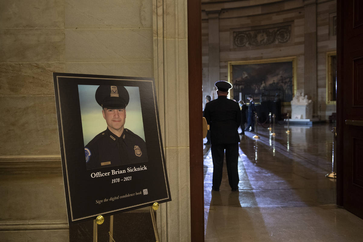 FILE - In this Feb. 2, 2021, file photo a placard is displayed with an image of the late U.S. C ...