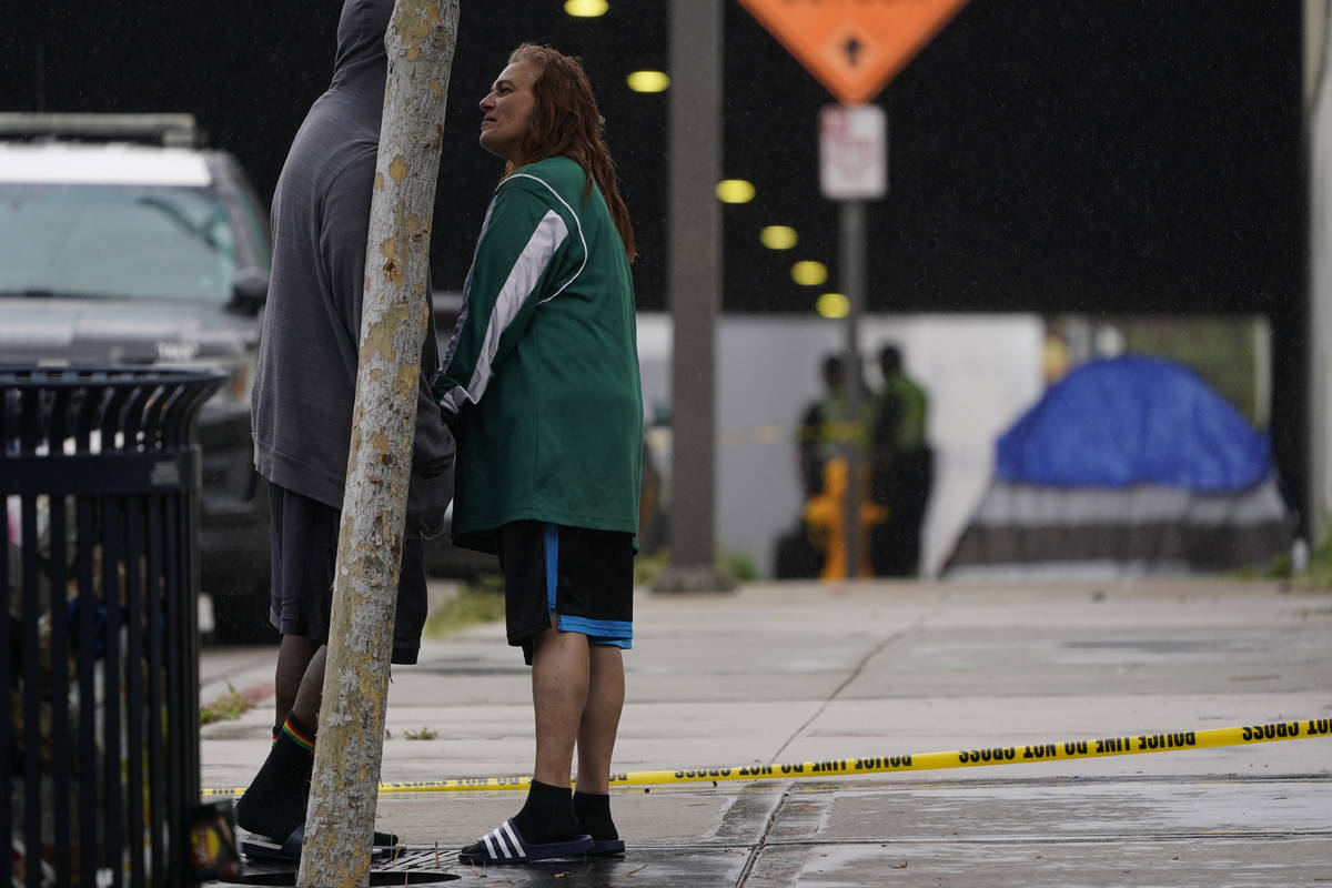 Lisa Brotzman, right, stands with Terry Goffigan at the scene of a deadly accident Monday, Marc ...