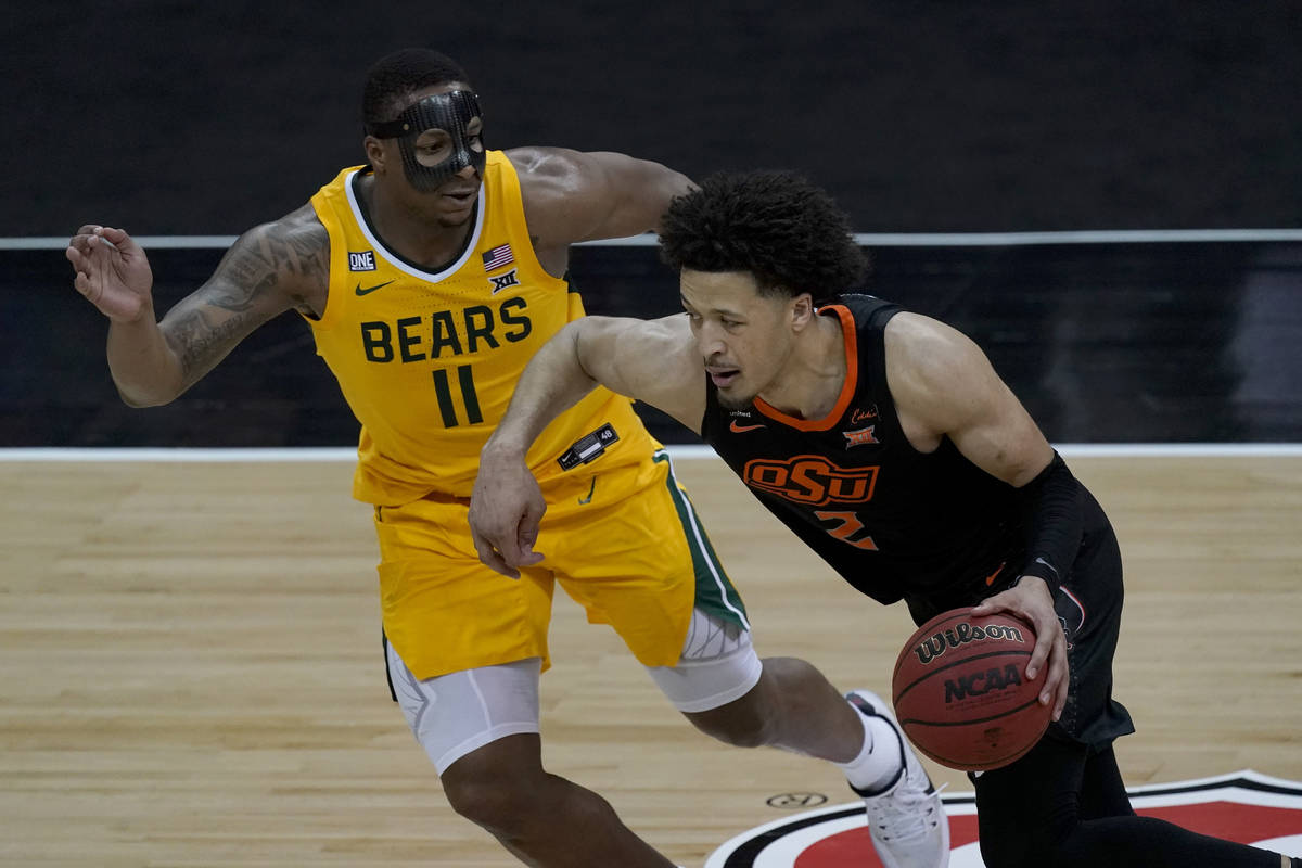 Oklahoma State's Cade Cunningham (2) drives under pressure from Baylor's Mark Vital (11) during ...