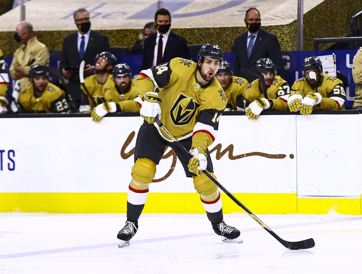 Golden Knights defenseman Nicolas Hague (14) looks to pass the puck during the second period of ...
