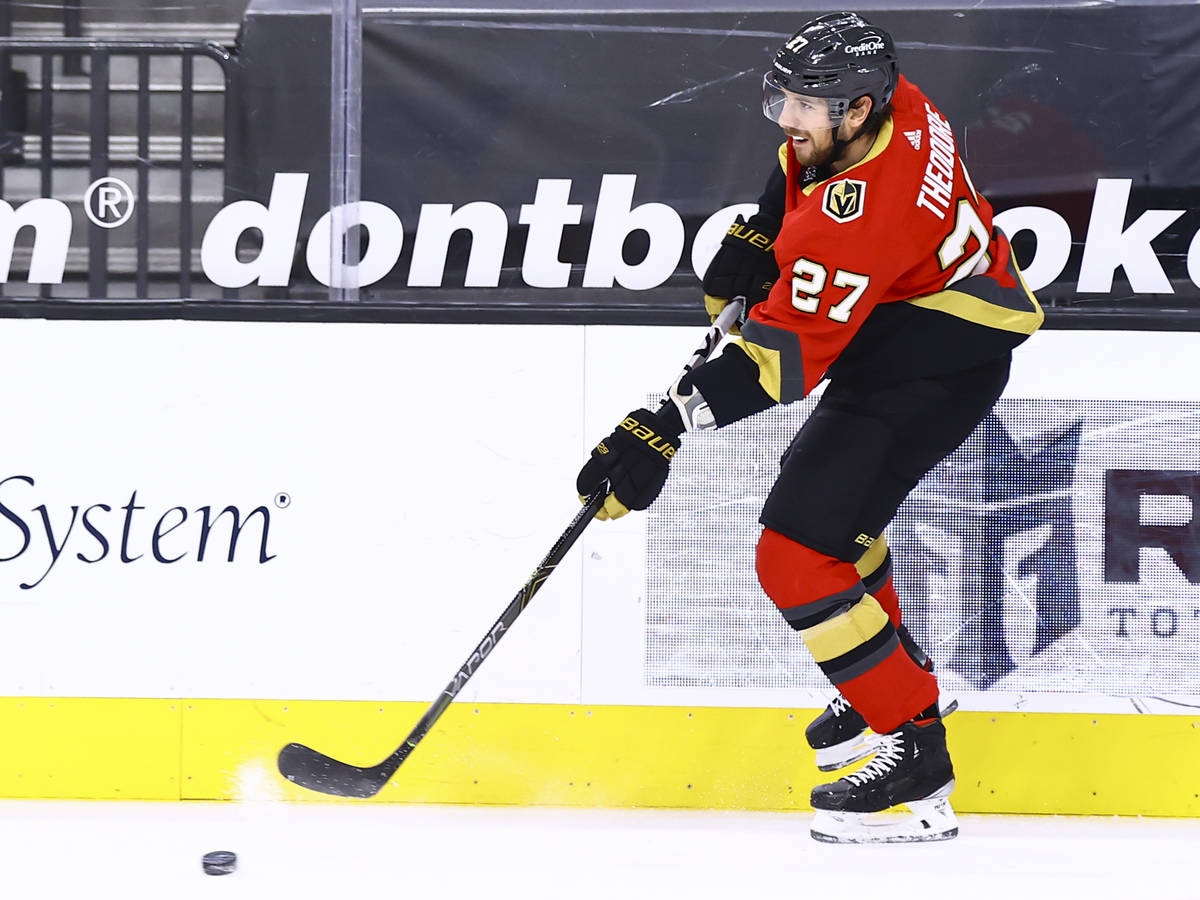 Golden Knights' Shea Theodore passes the puck during the first period of an NHL hockey game aga ...