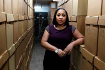 Fulton County District Attorney Fani Willis poses among boxes containing thousands of primal ca ...