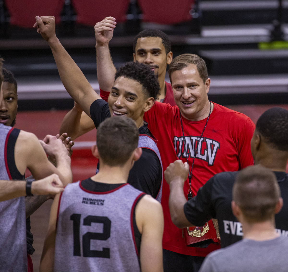 UNLV basketball head coach T. J. Otzelberger comes together with his players ending practice in ...