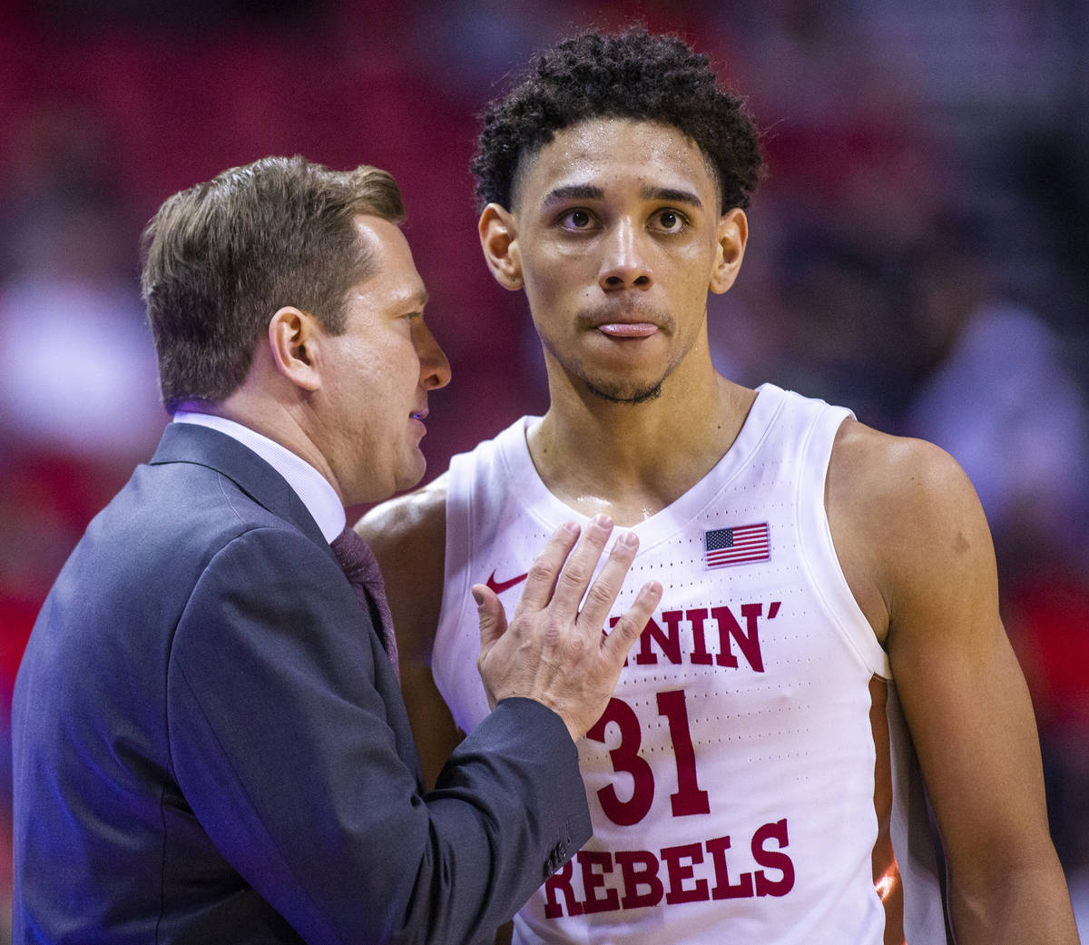 UNLV Rebels head coach T. J. Otzelberger confers with UNLV Rebels guard Marvin Coleman (31) on ...