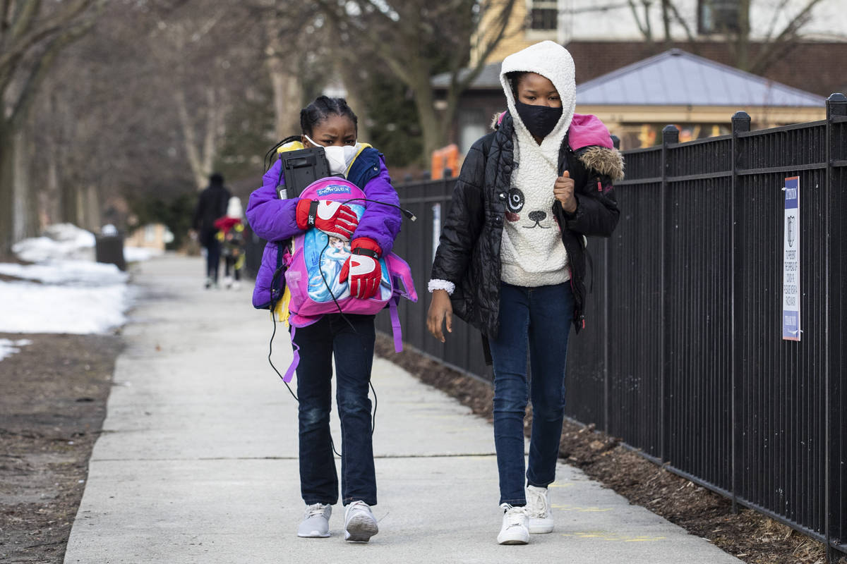 FILE - In this Monday, March 1, 2021, file photo, children walk to George B. Armstrong Internat ...