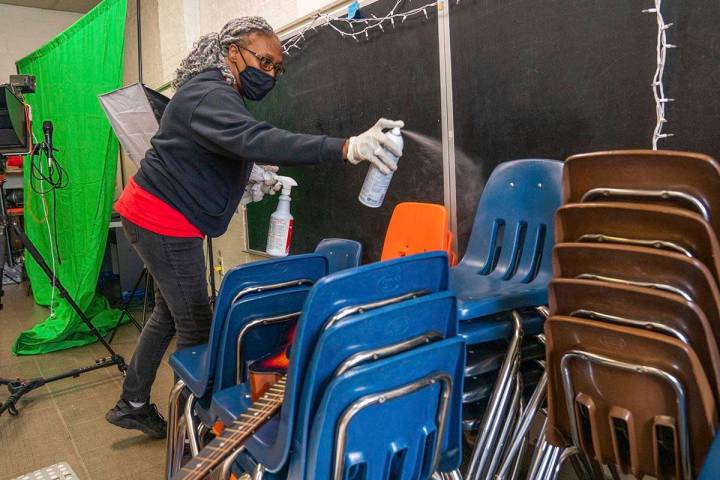 In this Thursday, March 4, 2021, file photo, Latisha Bledsoe cleans chairs in the music room at ...