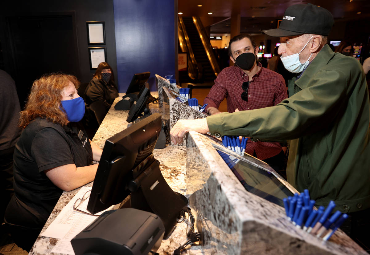 Matt Metcalf, Circa Sports sportsbook director, center, and ticket writer Amy Rafferty visit wi ...