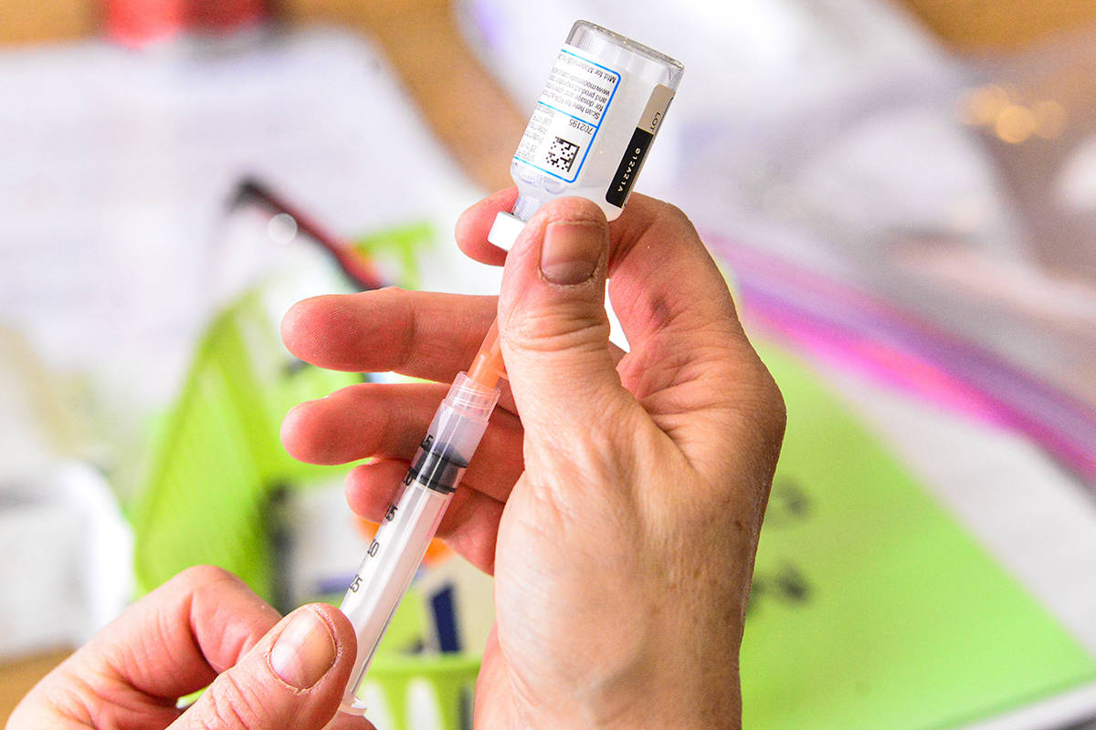 A nurse draws up the Moderna COVID-19 vaccine during a vaccination clinic that was run by the V ...