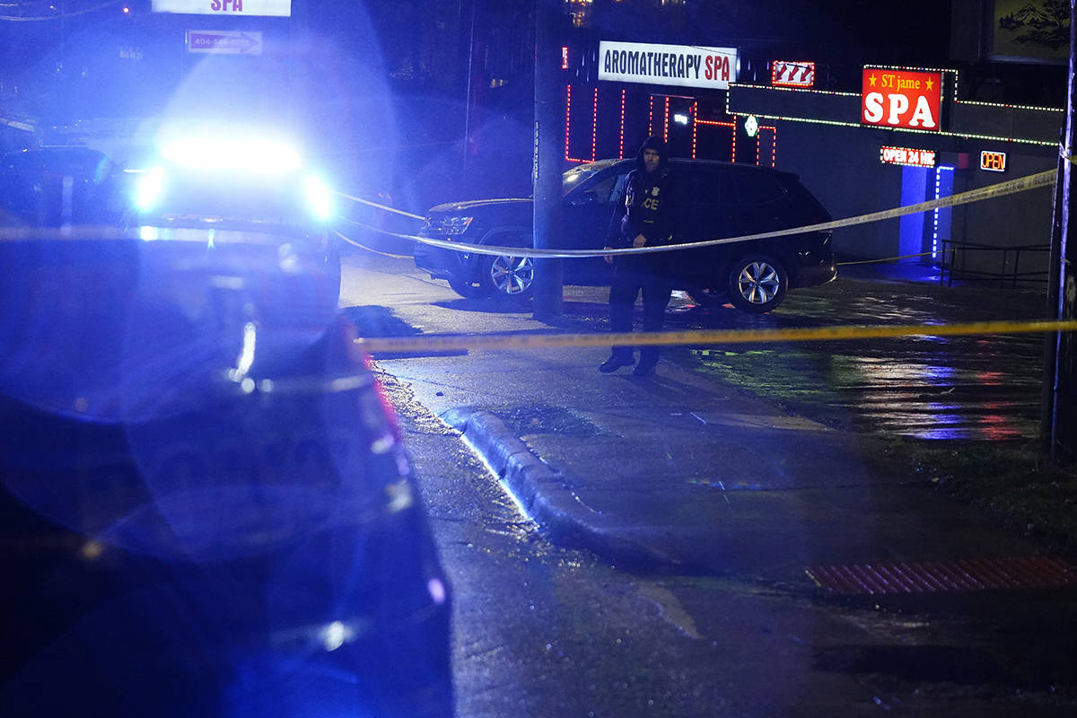 An official stands in front of a massage parlor after a shooting, late Tuesday, March 16, 2021, ...
