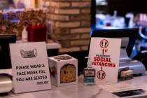 Signs at Nora's Italian Cuisine indicate some of the steps the restaurant is taking to help pre ...