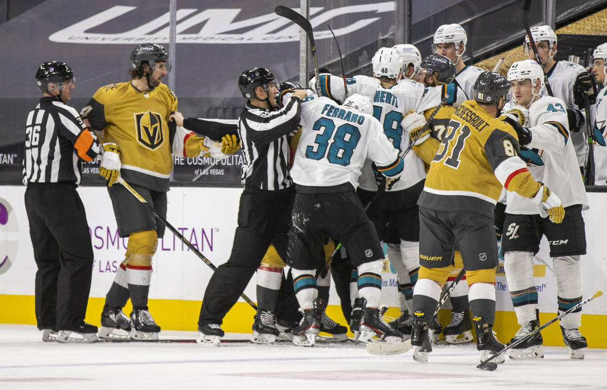 Golden Knights and San Jose Sharks players fight during the second period of an NHL game at T-M ...