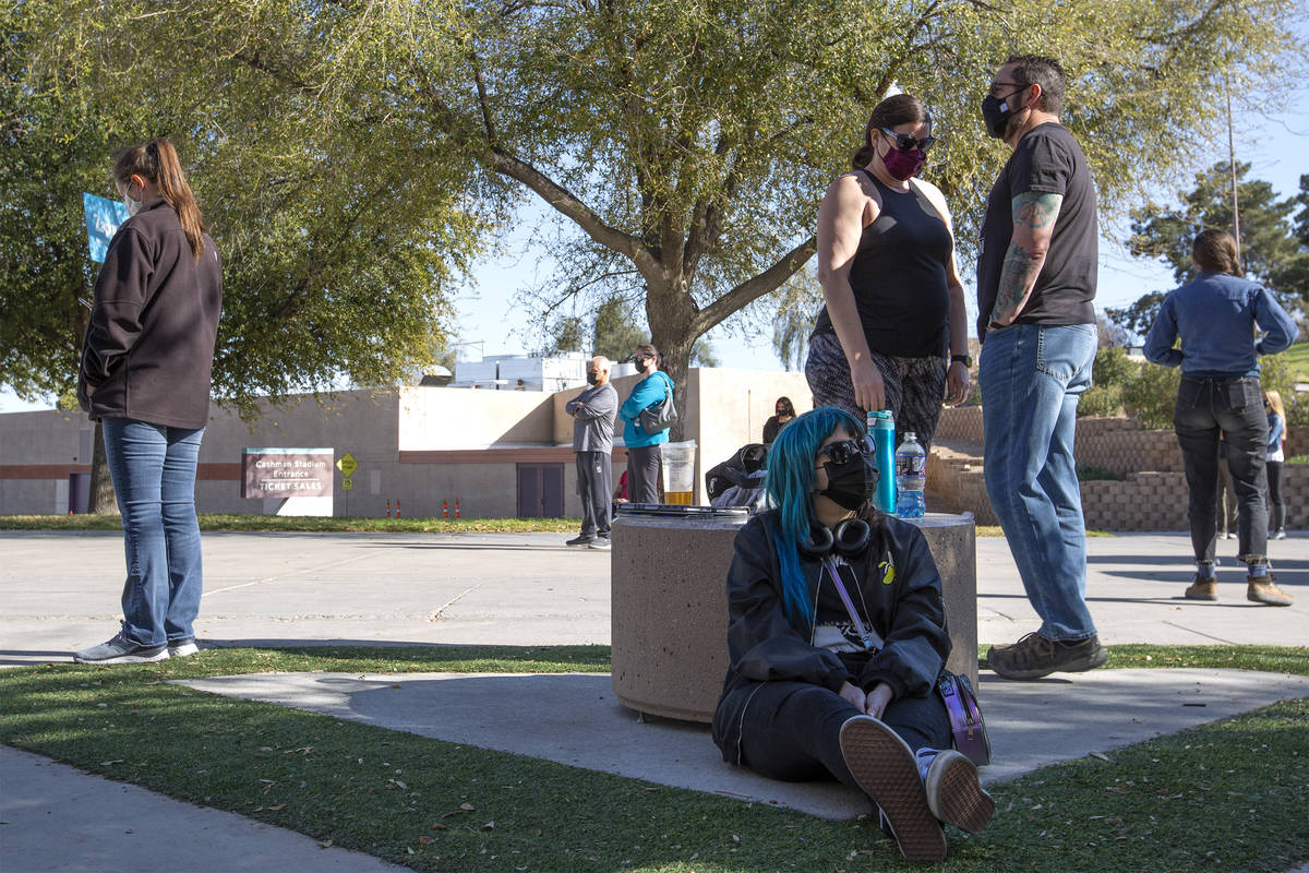 Allyson Fernandez, bottom center, waits to be called from a standby list for a COVID-19 vaccine ...