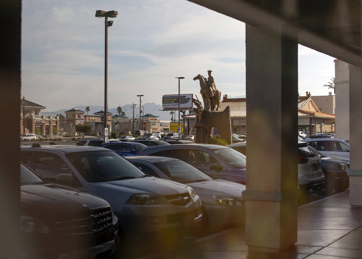 Chinatown Plaza is reflected in the window of a shop on Wednesday, March 17, 2021, in Las Vegas ...