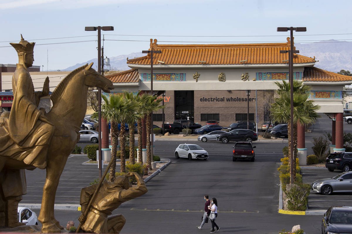 Pedestrians cross the parking lot at Chinatown Plaza on Wednesday, March 17, 2021, in Las Vegas ...