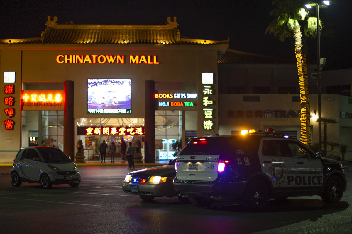 Metropolitan police are stationed in the Chinatown Plaza parking lot on Wednesday, March 17, 20 ...