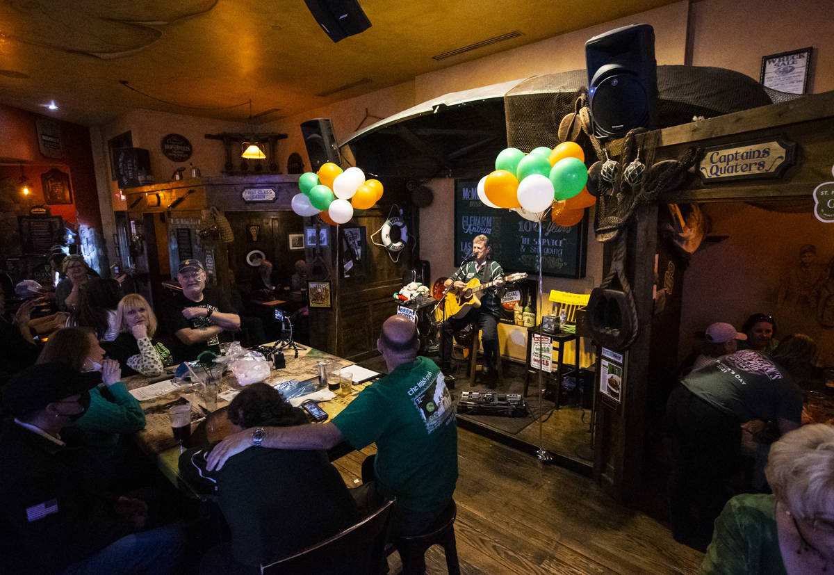 Musician John Windsor performs as people gather to celebrate St. Patrick's Day at McMullan's Ir ...
