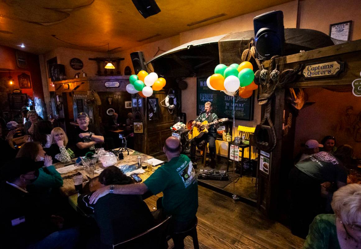 Musician John Windsor performs as people gather to celebrate St. Patrick's Day at McMullan's Ir ...