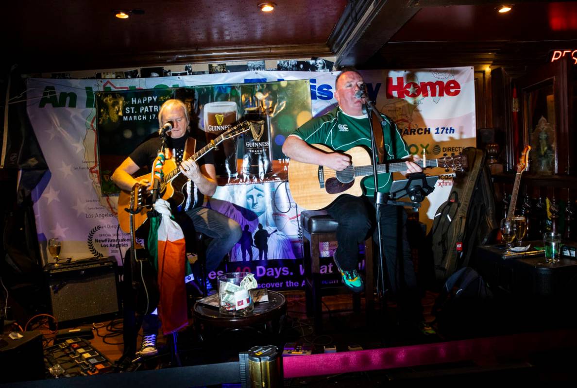 David Browne, left, and Dave Rooney, of The Black Donnellys, perform as people gather to celebr ...