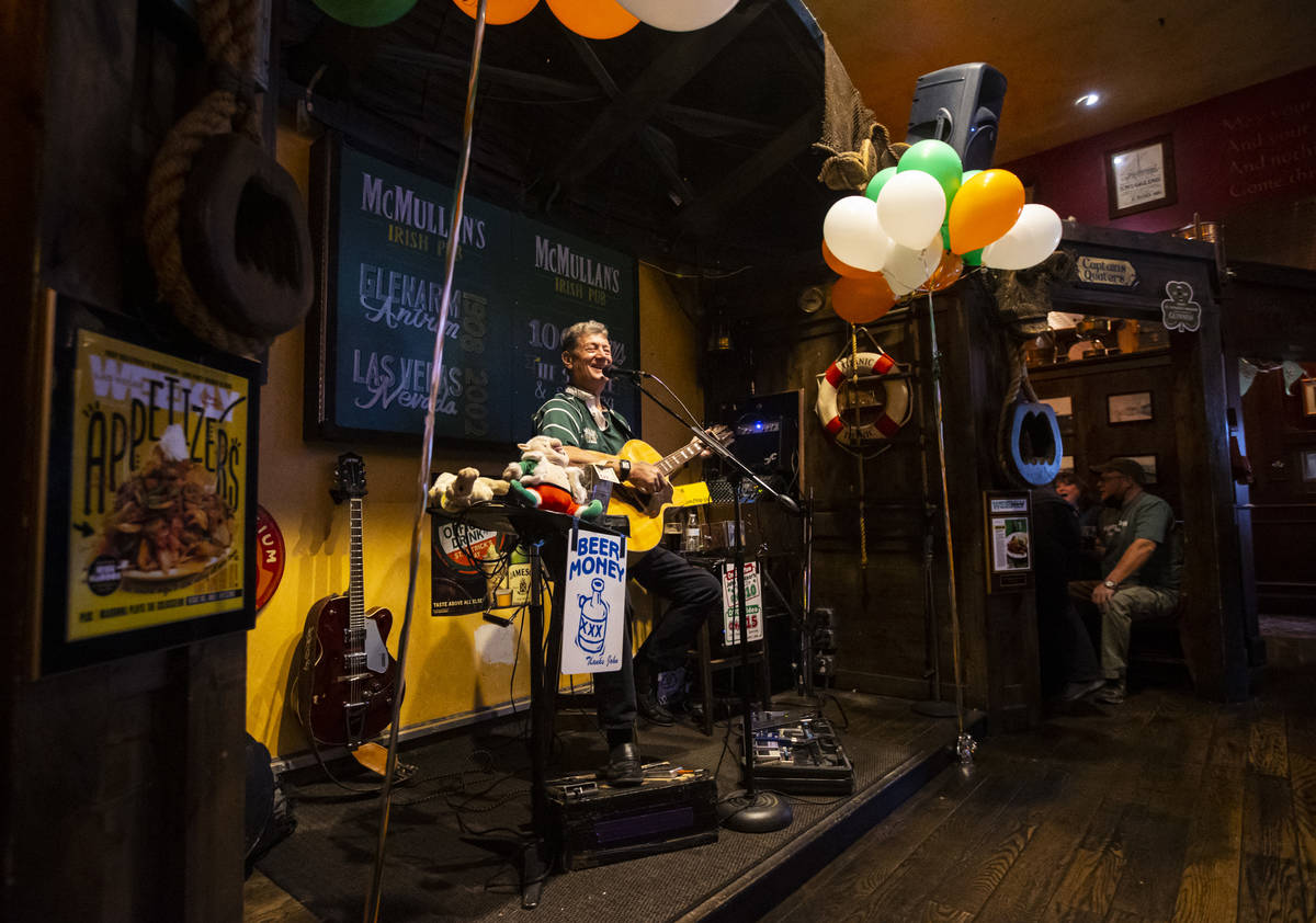 Musician John Windsor performs as people gather to celebrate St. Patrick's Day at McMullan's Ir ...