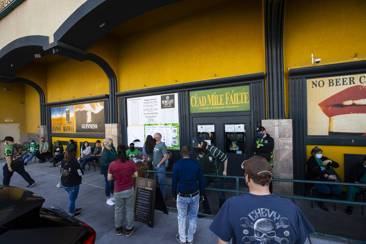 People wait for their reservations as they gather to celebrate St. Patrick's Day at McMullan's ...
