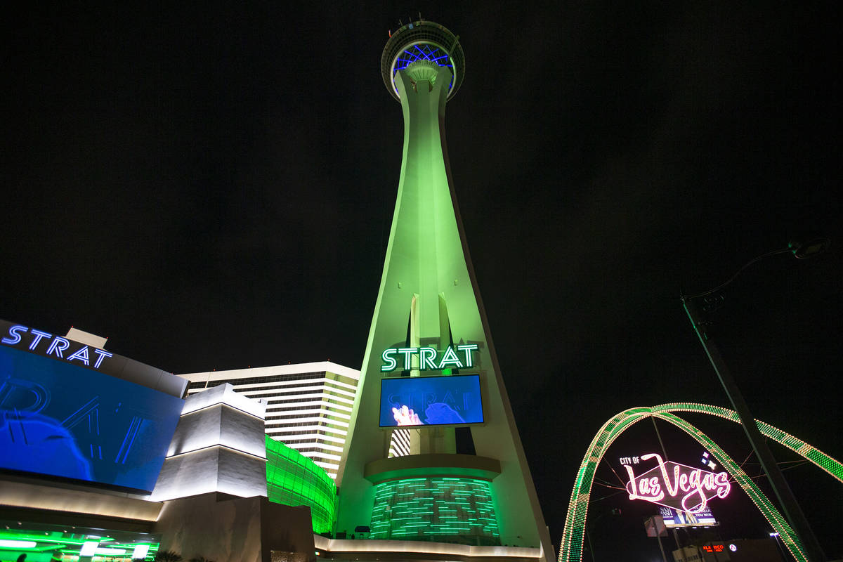 The STRAT and the Las Vegas Boulevard Gateway Arches are lit green for St. Patrick's Day on Wed ...