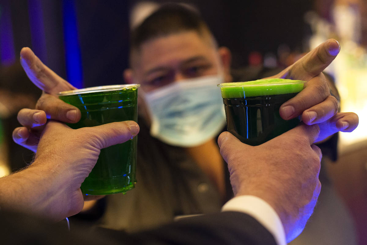 A bartender at REMIX Lounge serves green beer for St. Patrick's Day at The STRAT on Wednesday, ...