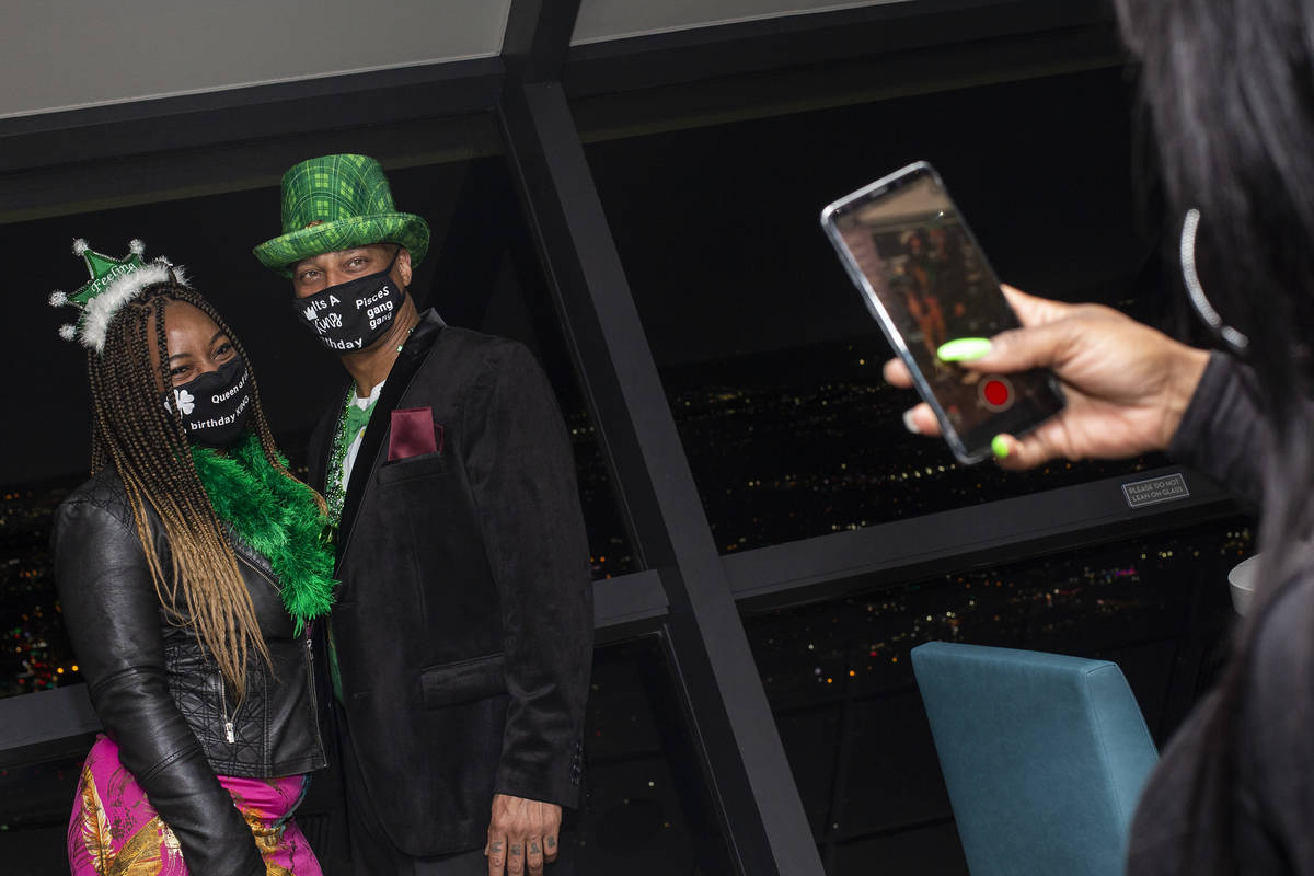 Asia Harris photographs Ashley Brittain, left, and Rob Robinson, all of New Jersey, on St. Patr ...